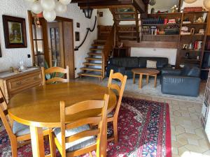 a living room with a wooden table and chairs at Ferienhaus Natternberg Spacious apartment large living room 4 bedrooms garden quiet near Deggendorf in Deggendorf