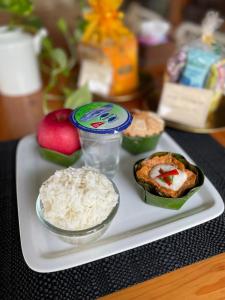 a tray with rice and a container of food on it at อัมพวาริเวอร์วิว Amphawa River View in Samut Songkhram
