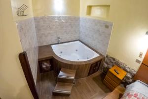 a large bath tub in a bathroom with a bed at Cusco'sHome 3 in Cusco +34 photos