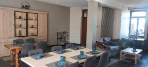 a living room with a table and chairs at La Forge De Labbaye in Liessies