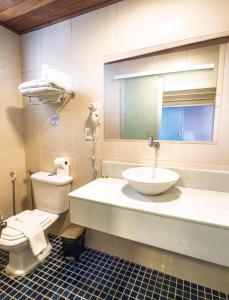 a bathroom with a sink and a toilet and a mirror at Pousada Mareia in Morro de São Paulo +22 photos