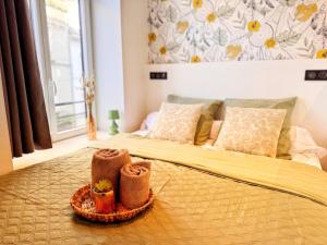 a bedroom with a bed with two towels on it at Le Cocon de Rose & Achille in Boulogne-sur-Mer