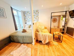 a small bedroom with a bed and a mirror at Le Cocon de Rose & Achille in Boulogne-sur-Mer