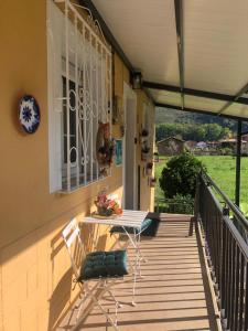 a porch with a table on the side of a house at Casa Mari Carmen in Salas