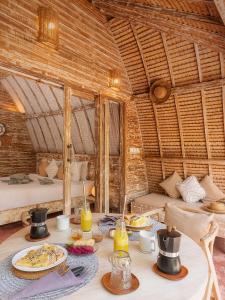 a room with a table with plates of food on it at Private Pool Romantic Villa - Adults Only - VILLA PALMA - Gili Meno in Gili Meno