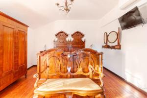 a large wooden bed in a room at "Venetian Elegance Villa" - near Venice historic center in Mira