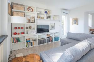 a living room with a couch and a tv at Torre Dell'Amore, Genova, Seaview in Genoa +46 photos