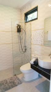 a bathroom with a toilet and a sink at Garden Villa in Srithanu