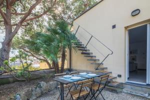 a patio with a table and chairs and a staircase at Torre Dell'Amore, Genova, Seaview in Genoa