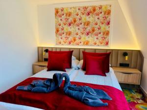 a bedroom with a bed with towels on it at Villa Peonia-Szauna & Relax in Keszthely