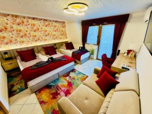 a living room with two beds and a couch at Villa Peonia-Szauna & Relax in Keszthely +11 photos