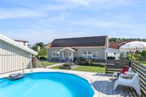 a home with a swimming pool and a house with a solar roof at Luxury villa with pool in Bro