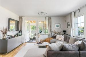 a living room with a couch and a table at Luxury villa with pool in Bro