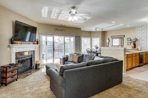 a living room with a couch and a fireplace at Lake View + Pool Access: Waterfront Ozark Escape! in Four Seasons
