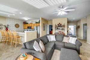 a living room with a couch and a kitchen at Lake View + Pool Access: Waterfront Ozark Escape! in Four Seasons