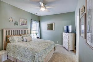 a bedroom with a bed and a ceiling fan at Lake View + Pool Access: Waterfront Ozark Escape! in Four Seasons +30 photos