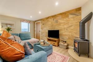 a living room with a blue couch and a wood stove at 2 Bed in Castleton oc-f34013 in Castleton
