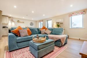 a living room with a blue couch and a table at 2 Bed in Castleton oc-f34013 in Castleton