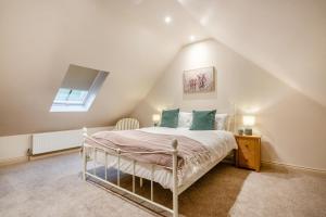 a bedroom with a white bed in a attic at 2 Bed in Castleton oc-f34013 in Castleton