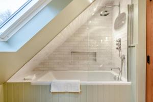 a bathroom with a bath tub in a attic at 2 Bed in Castleton oc-f34013 in Castleton +34 photos