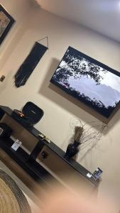 a living room with a tv on the wall at Bokoba Condo Tulum Maia in Tulum