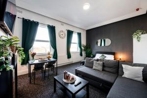 a living room with a couch and a table at Spacious City-Centre Apartment · Sleeps 4 in Nottingham