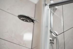 a shower with a shower head in a bathroom at Spacious City-Centre Apartment · Sleeps 4 in Nottingham
