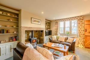 a living room with a couch and a fireplace at 2 Bed in Chatton oc-r27205 in Chatton