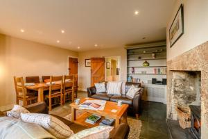 a living room with a couch a table and a fireplace at 2 Bed in Chatton oc-r27205 in Chatton