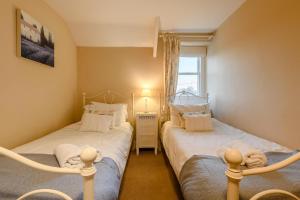 two twin beds in a room with a window at 2 Bed in Chatton oc-r27205 in Chatton