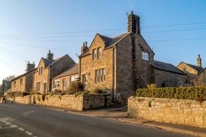 a row of brick houses on the side of a street at 2 Bed in Chatton oc-r27205 in Chatton