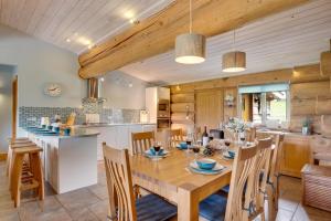 a kitchen and dining room with a wooden table and chairs at 4 Bed in Alston oc-nb575 in Alston
