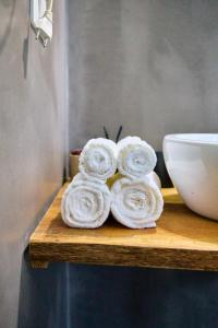 a pile of towels sitting on a counter next to a sink at Palazzo Mercanzia in Lecce +114 photos