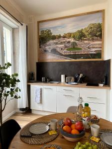 a kitchen with a table with fruit on it at CLIM - Hypercentre - Arche en pierre in Nîmes
