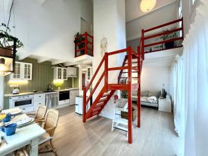 a kitchen and dining room with a red staircase in a room at Casa Divera in Noordwijkerhout