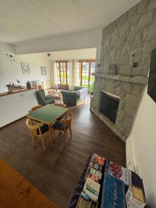 a living room with a table and a fireplace at Hostería Cumbres Blancas in Esquel