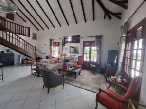a large living room with couches and a tv at Chrysalide in Baillif