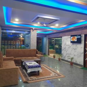 a living room with a couch and a table at Surakha INN LLP in Siliguri