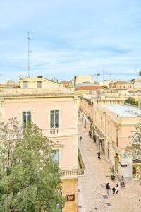 a view of a city street with buildings at Palazzo Mercanzia in Lecce