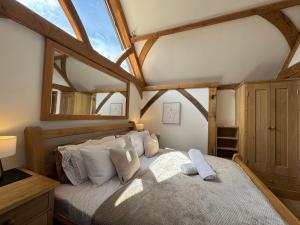 a bedroom with a large bed in a room at The barn Alexandra mews in Heathfield