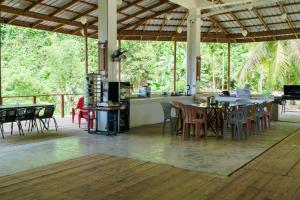 a pavilion with tables and chairs on a deck at Utopia Hostel in Ngermid