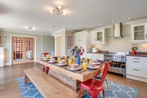 a kitchen with a wooden table with glasses of orange juice at 5 Bed in Seahouses oc-nb621 in Seahouses