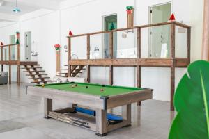a billiard table in a room with a rack at Utopia Hostel in Ngermid