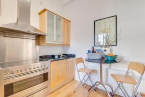 a kitchen with a stove and a table with chairs at 2 Bed in Embleton oc-nb1960 in Embleton