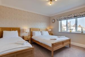 a bedroom with two beds and a window at 5 Bed in Seahouses oc-nb621 in Seahouses