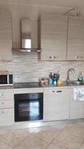 a kitchen with a stove and a sink and a dishwasher at Colle Sul Mare in Termoli