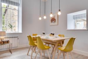 a dining room with a table and yellow chairs at 2 Bed in Beadnell oc-gd1889 in Beadnell
