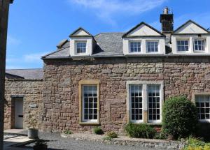 an old stone house with white windows at 2 Bed in Beadnell oc-gd1889 in Beadnell