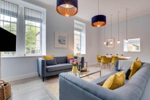 a living room with a blue couch and yellow pillows at 2 Bed in Beadnell oc-gd1889 in Beadnell