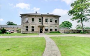 an old house with a grassy field in front of it at 2 Bed in Beadnell oc-gd1869 in Beadnell